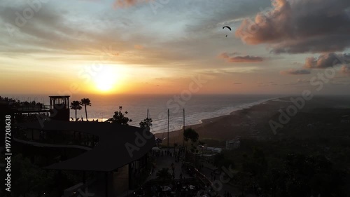 Aerial drone shot of the famous Obelix Sea View viewpoint during a vibrant sunset at the southern coast of Java.