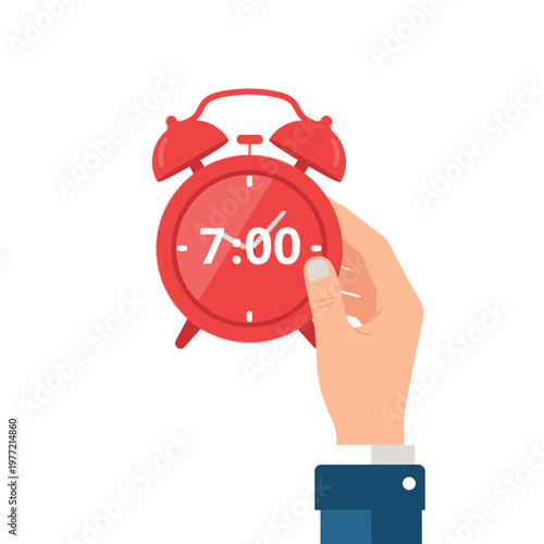 Hand holding red alarm clock showing 7:00 AM, wake up call, time management concept