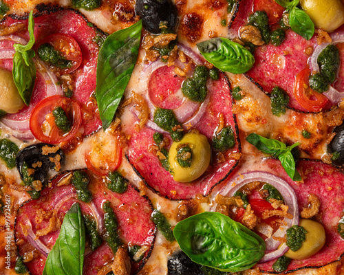Gourmet pizza with salami, olives, cherry tomatoes