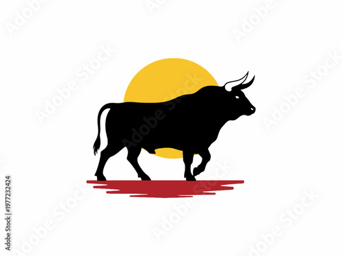 Bull silhouette standing before yellow sun and red horizon