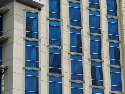 a magnificent and luxurious hotel building with blue glass