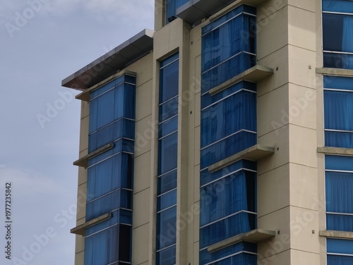 a magnificent and luxurious hotel building with blue glass