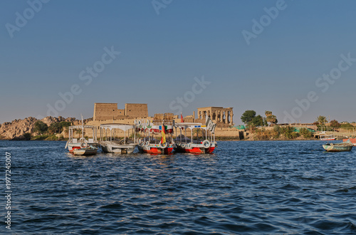 Fotografie Boats on the Nile River with Philae Temple in the Distance, Aswan Egypt