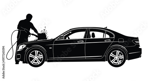 Man washing a black car with a pressure washer striking black silhouette