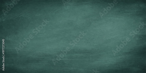 A dark and aged green chalkboard background with a grunge texture and vintage paper pattern creates a blank canvas for art on a dirty, empty wall backdrop