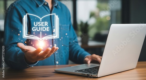 A man using a laptop with a user guide icon above his hand.