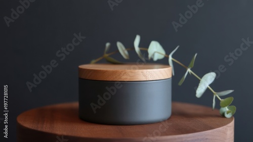 Minimalist kitchen utensils in gray ceramic container on wooden board