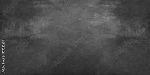 A dark vintage grunge blackboard with a textured gray concrete surface and a blank chalkboard frame design on a dirty old paper wall backdrop