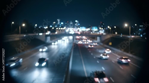 Highway at night with blurred cars and city lights in the distance
