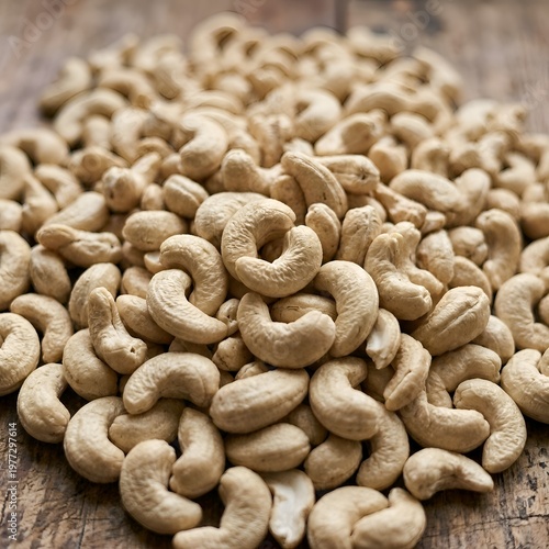 Pile of Raw Cashew Nuts on Wooden Surface, Close-up View of Light Brown Snack Food
