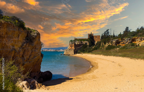 Quadro su tela Castelo de Ferragudo, perched on a rocky cliff, stands against a clear blue sky in Portugal