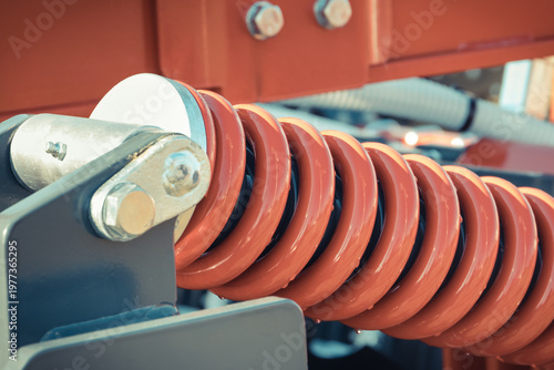 Steel spring as part of heavy agricultural, industrial machine. Technology