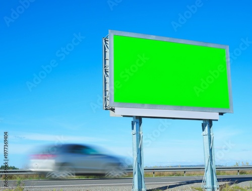 A green billboard on the highway.