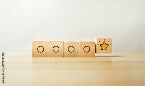 Billede på lærred Outstanding performance concept with glowing star icon on wooden blocks among si