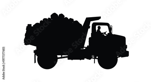 Black silhouette of a loaded dump truck with a driver silhouette