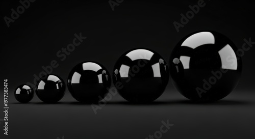 Five Reflective Black Spheres Increasing In Size On A Dark Background