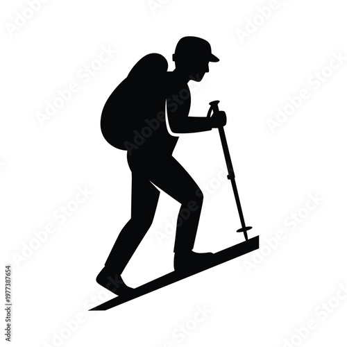 Silhouette of a person ski mountaineering or trekking uphill with a backpack and poles