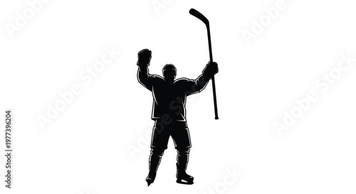 Celebrating hockey player with raised stick in dramatic silhouette