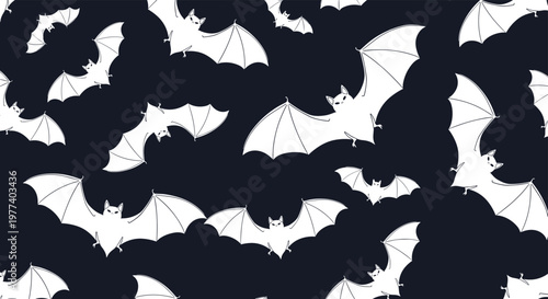 Seamless spooky pattern featuring numerous white bats in different flight poses scattered over a dark navy blue background for Halloween.