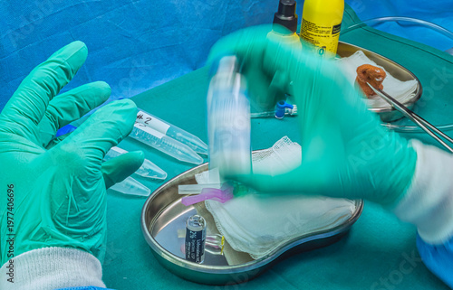 Nurse holds ampoule of anesthesia, preparation to extract cerebrospinal fluid to investigate causes in a person affected by transverse myelitis 