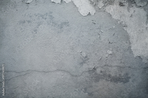 Concrete wall with longitudinal crack and peeling paint.