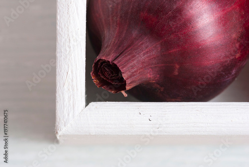 onions on white wood tray, wooden table background