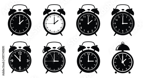 Eight black alarm clocks displaying different times a stark silhouette