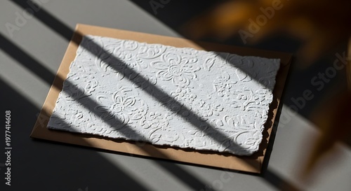 Close up of an old weathered map in a wooden frame bathed in dramatic light and shadow