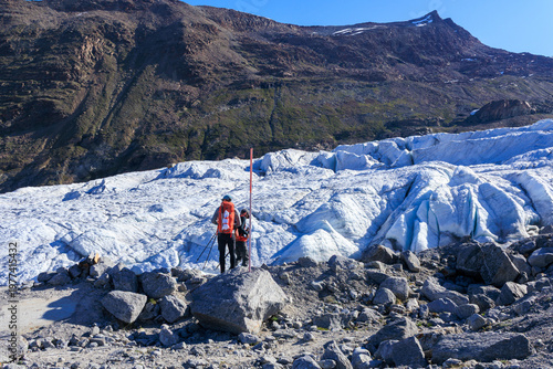 Mountaineers in front of Gorner Glacier, Gornergrat, summit Stockhorn and mountain panorama in Pennine Alps, Switzerland