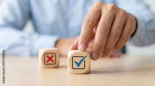Wooden cubes with blue check and red cross signs, representing a businessman's choice to approve or reject a business project proposal concept.