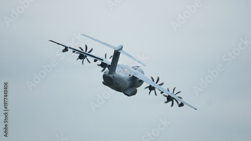 Aircraft soaring through cloudy skies showcasing Airbus A400M Atlas in action with aerial refueling capability