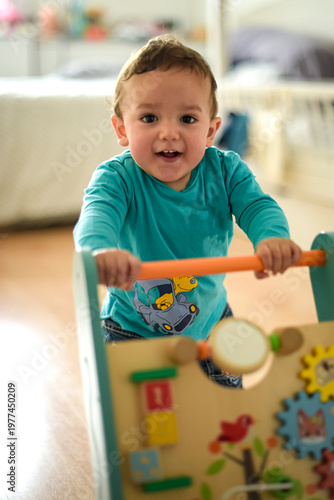 young child taking their first steps with a walker