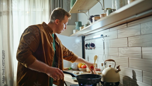 Man salting tasty dish in frying pan cooking nutritious food kitchen closeup.