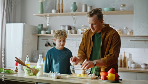 Εκτύπωση καμβά Caring father teaching culinary little attentive son standing kitchen closeup