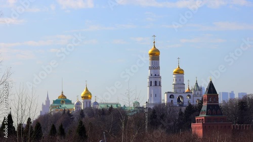 A picturesque view of the Kremlin featuring its iconic golden domes and towers against a vibrant sky, epitomising the historical and architectural grandeur of Russia.