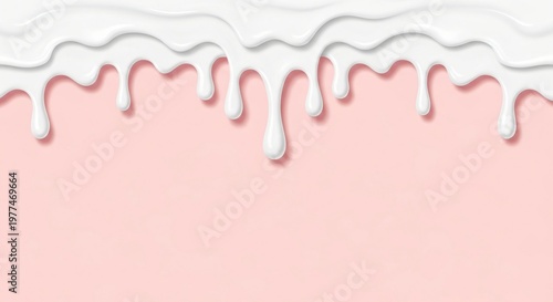 Melted white chocolate drips down a pink and white background surface.