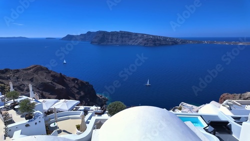 Canvas Print White houses on Santorini island cliff edge with coastal view, showcasing pictur