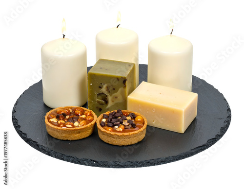 Candles, nuts tarts, cheese, and soap on slate