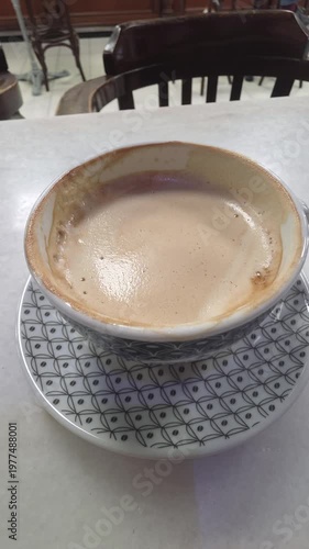 spoon stirring in the coffee cup
