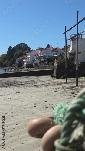 traditional fishing mooring with a Galician village in the background