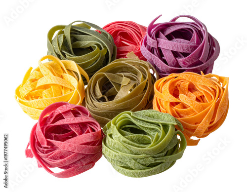 Vibrant, colorful nests of tagliatelle pasta on white
