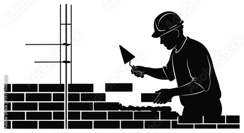 Construction worker applying mortar to bricks a striking black silhouette