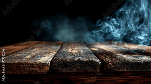 Close-up of rustic dark stained wooden table with a prominent grain texture tinted smoke across the surface against a deep black background making perfect mockup backdrop for product presentations.
