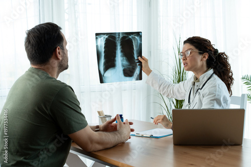 Doctor shows results to old patient x-ray of the lungs, smoking cigarettes problem. 