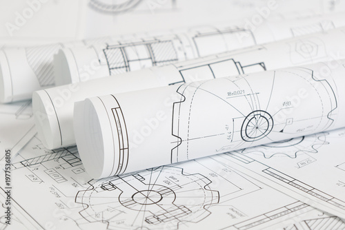 paper engineering drawings of industrial parts and mechanisms