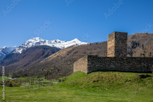 Photography Genos Castle and watchtower, Midi-Pyrenees, France, with the snow-capped Pyrenee