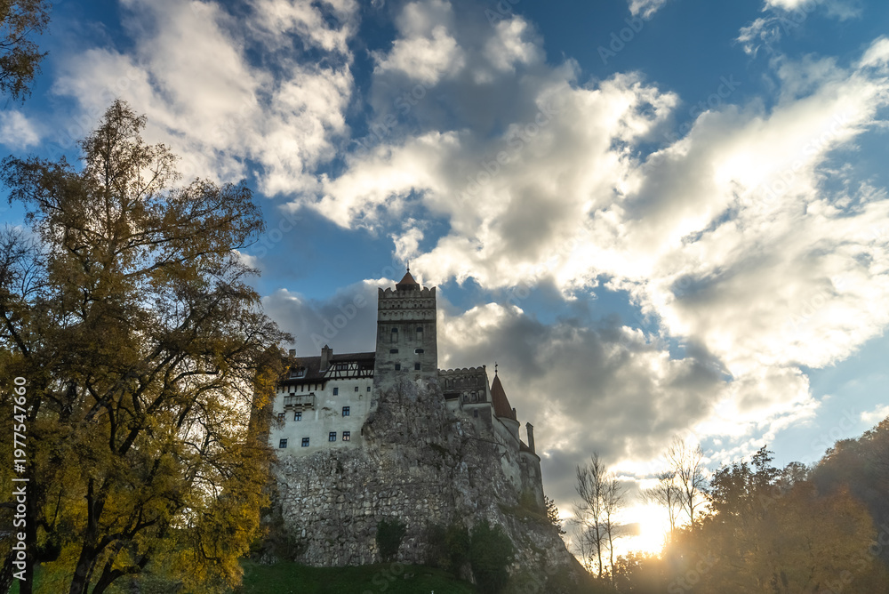 Fototapeta premium Bran castle fortress standing tall under dramatic autumn sky