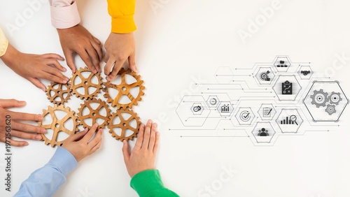 Photos Diverse hands gather around wooden gears, symbolizing teamwork and collaboration, complemented by digital technology graphics for business strategy and innovation