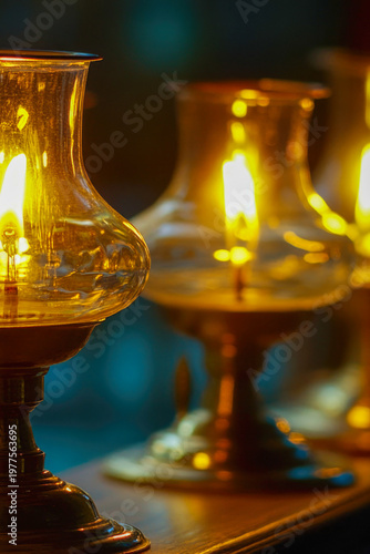 A close-up shot of a lit candle on a table, with the flame burning brightly. vertical frame