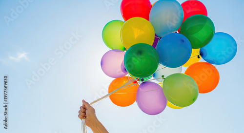 Colorful balloons in clear blue sky.